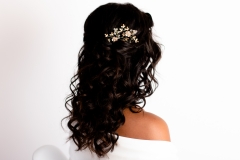 A bride wearing her naturally curly hair in a half up half down hairstyle for her wedding day. 