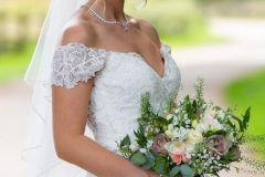 A bride at Gaynes Park on her wedding day, wearing a classic dress, wearing a soft updo and natural makeup.