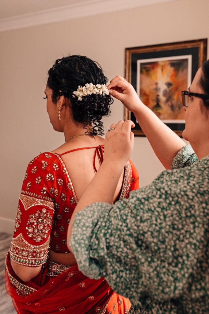 A bride with natural curls, having her hair styled by Vicky Jiggens, a curly bridal hair specialist. 